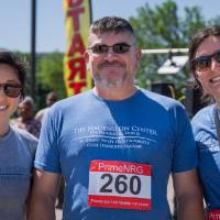 Three participants smile after finishing the race.